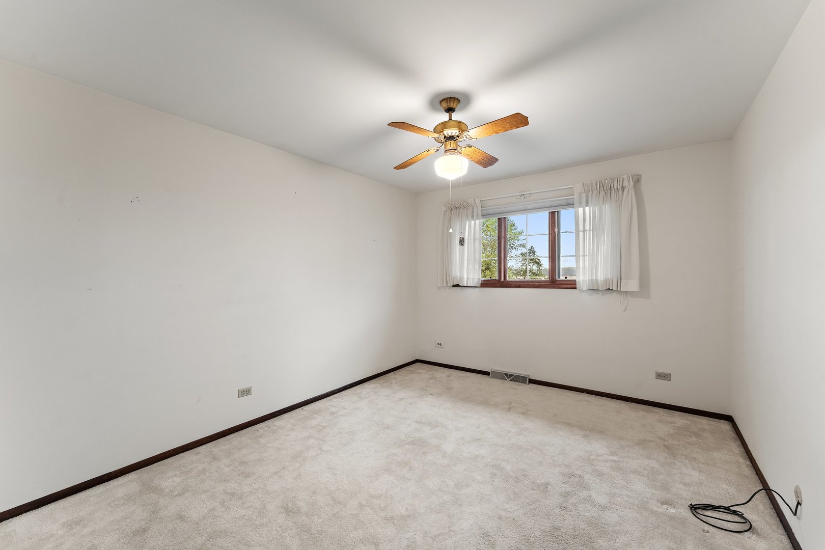 2929 East Danne Road Crete, IL 60417 - Photo 24 of 56 an empty room with windows and chandelier fan
