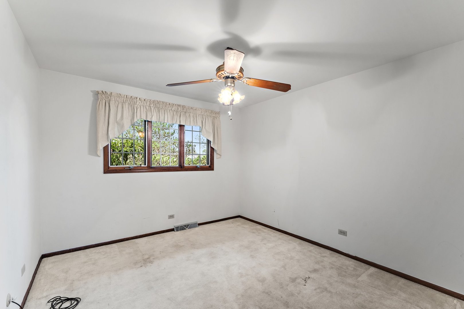 2929 East Danne Road Crete, IL 60417 - Photo 25 of 56 an empty room with a window and a ceiling fan