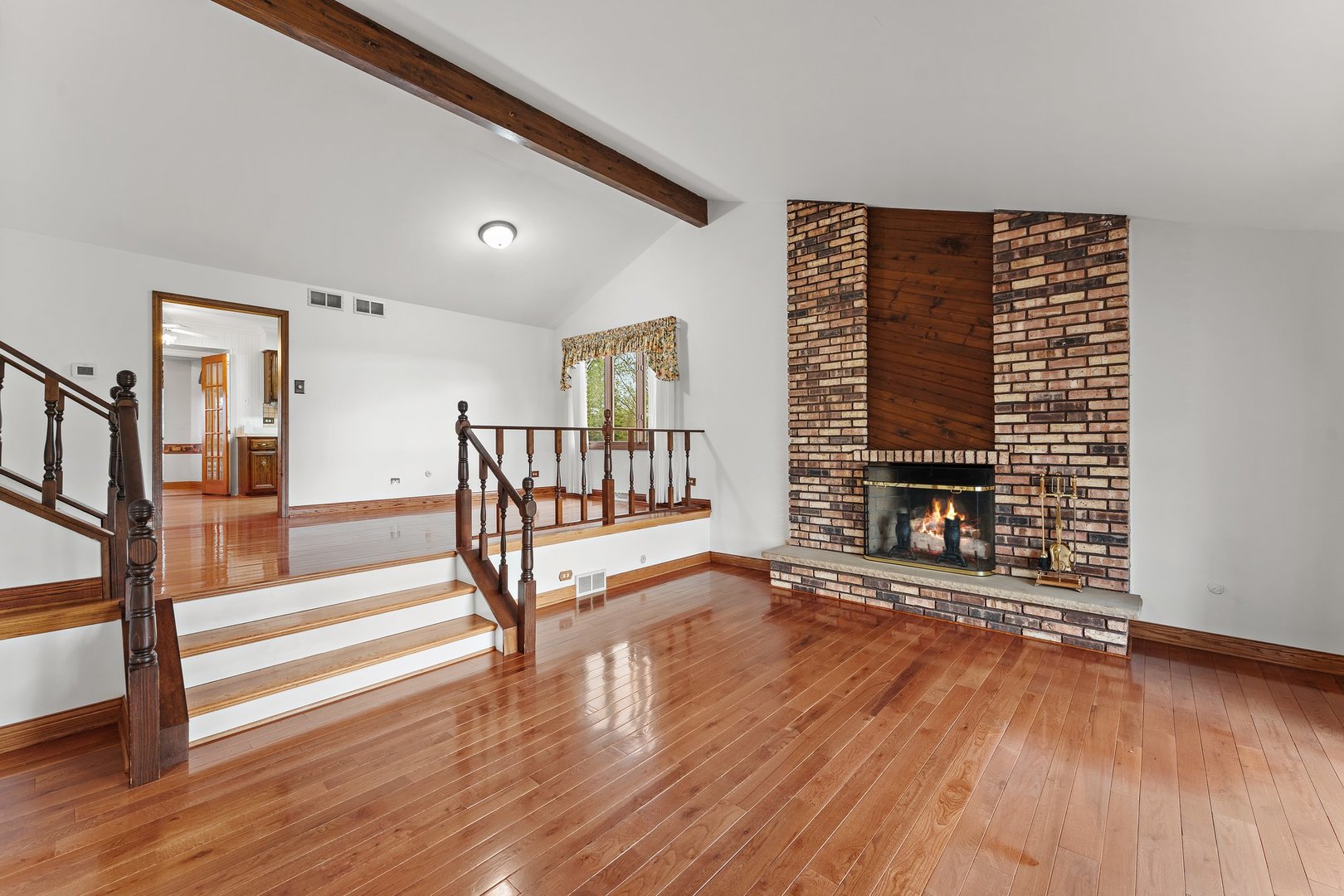 2929 East Danne Road Crete, IL 60417 - Photo 9 of 56 a view of an empty room with stairs wooden floor and window