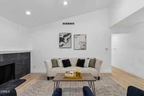 a living room with furniture and a fireplace