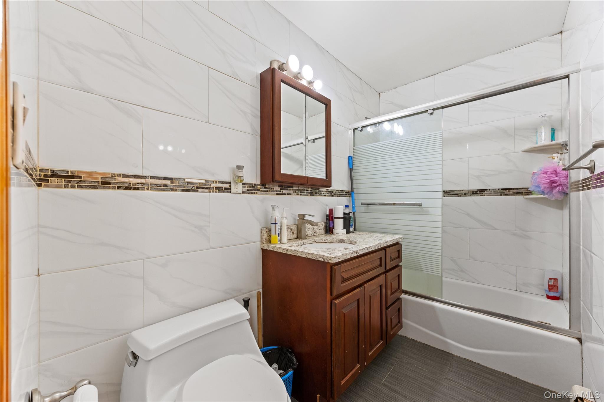 130-06 58th Road Queens, NY 11355 - Photo 13 of 15 a bathroom with a granite countertop sink toilet and shower