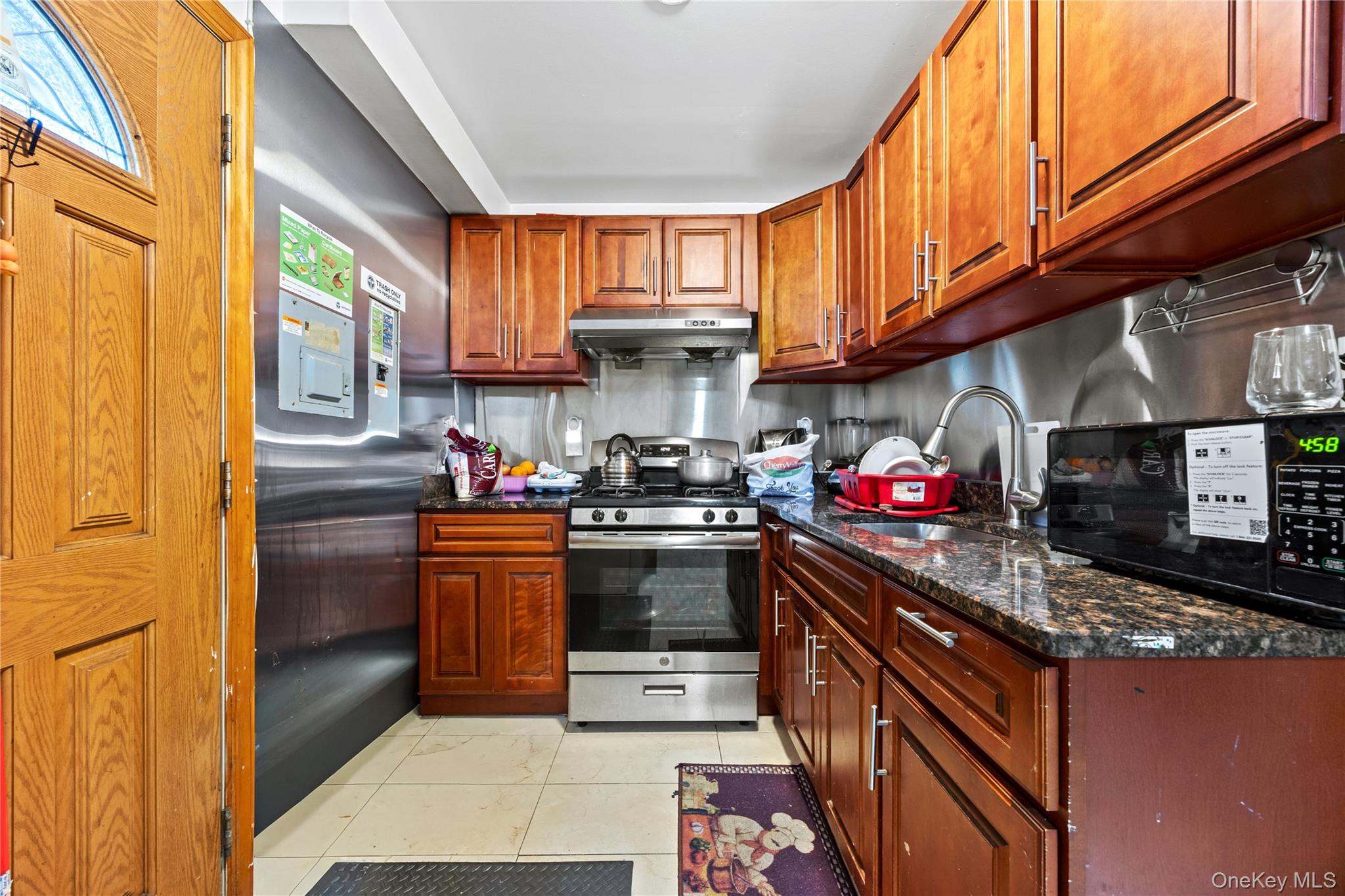 130-06 58th Road Queens, NY 11355 - Photo 2 of 15 a kitchen with stainless steel appliances granite countertop a stove and cabinets