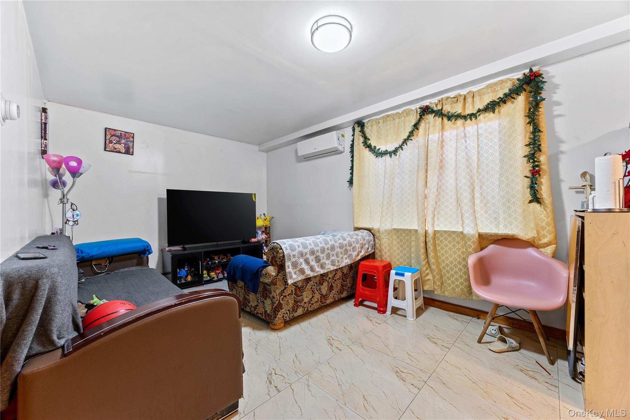 130-06 58th Road Queens, NY 11355 - Photo 3 of 15 a living room with furniture and a flat screen tv