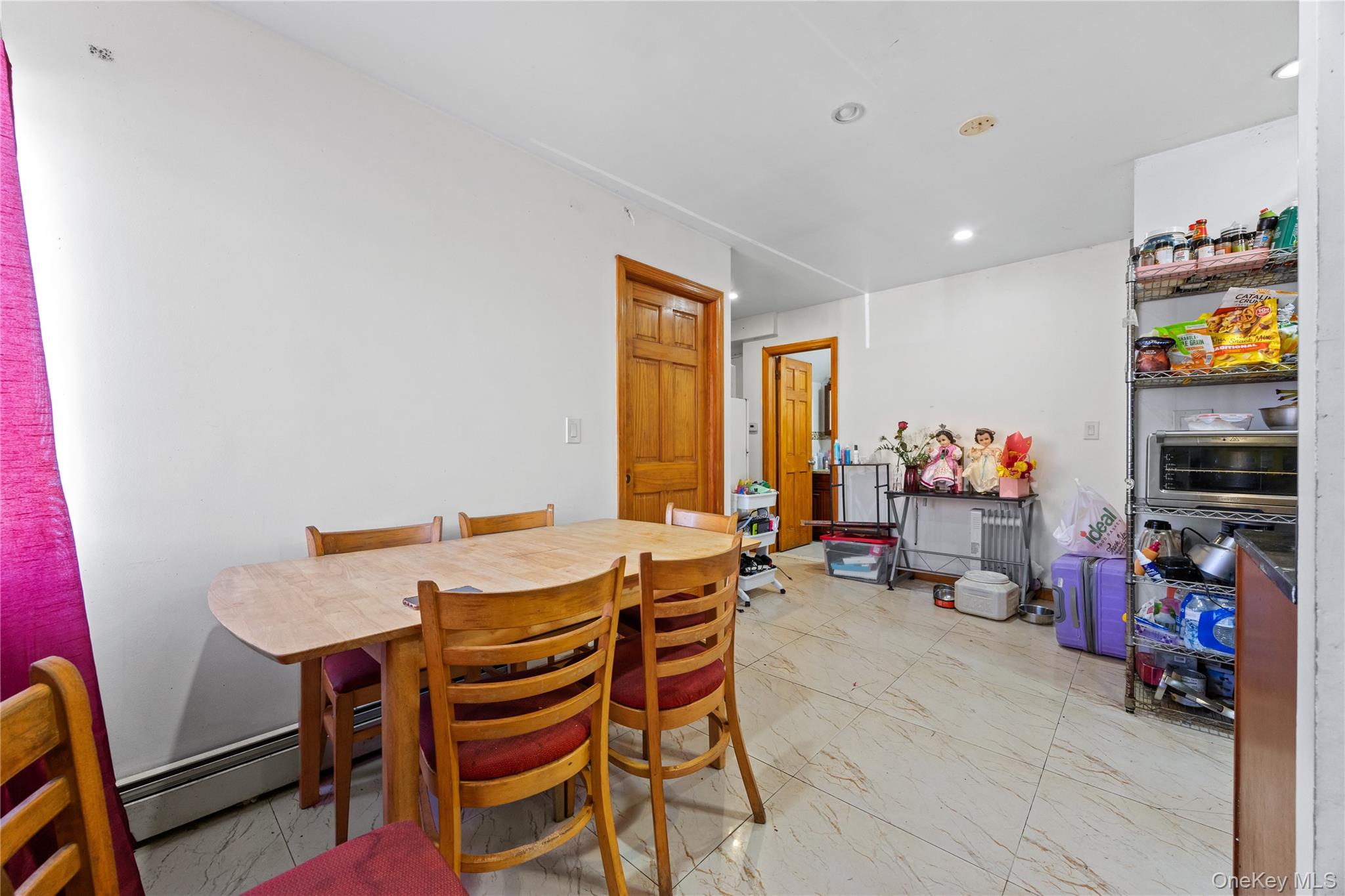 130-06 58th Road Queens, NY 11355 - Photo 8 of 15 a view of a dining room with furniture and a window
