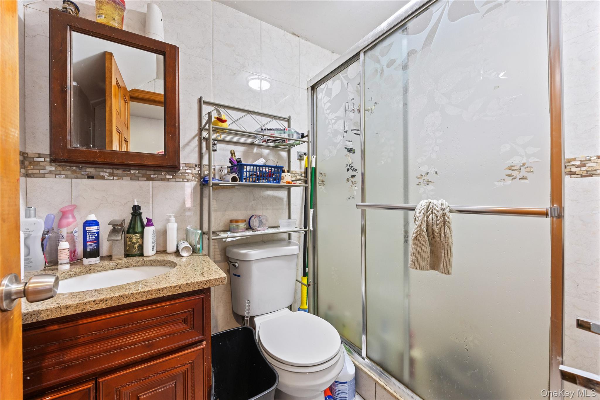 130-06 58th Road Queens, NY 11355 - Photo 9 of 15 a bathroom with a toilet a sink and a shower