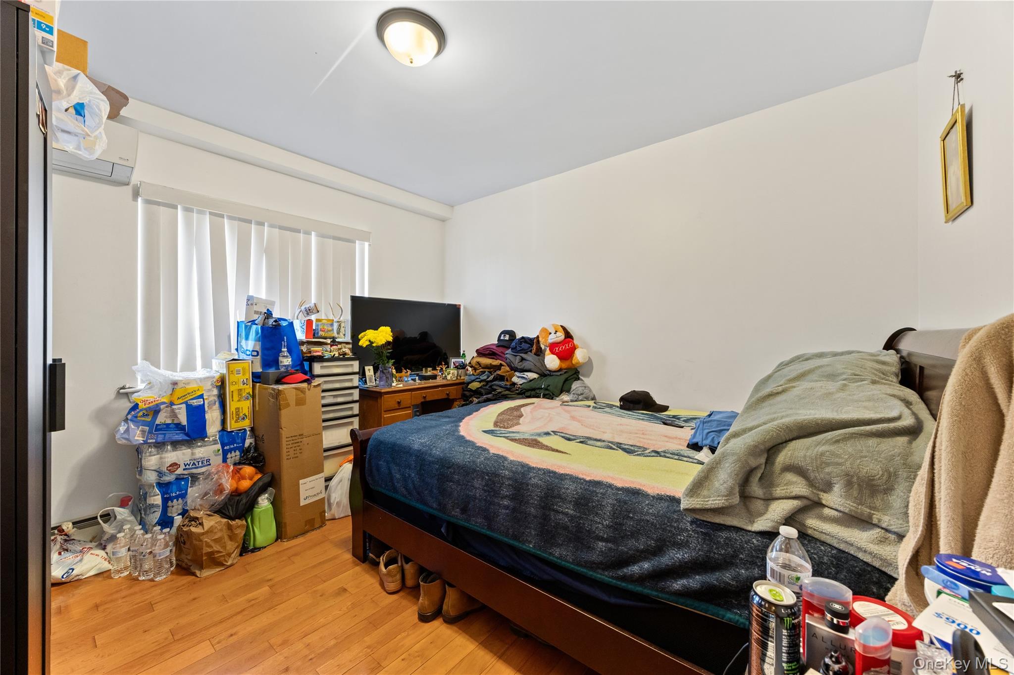130-06 58th Road Queens, NY 11355 - Photo 10 of 15 a bed room with furniture and a wooden floor
