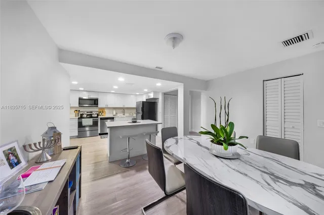 a kitchen with a table and chairs in it
