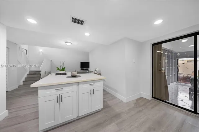 a kitchen with a sink and cabinets
