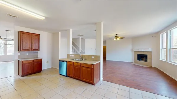 a view of kitchen with stainless steel appliances granite countertop a stove and a sink