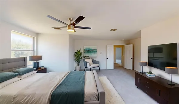 a bedroom with furniture and a flat screen tv