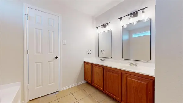 a bathroom with a double vanity sink and mirror