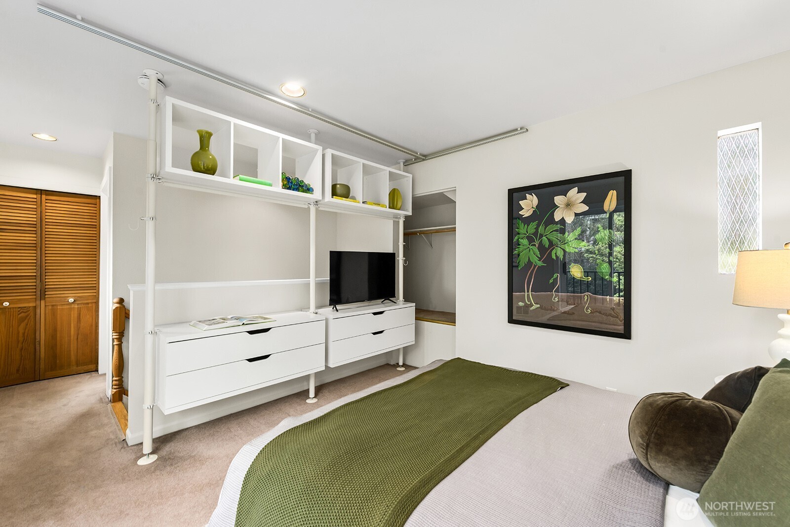 2620 East Roy Street Seattle, WA 98112 - Photo 19 of 27 a bedroom with furniture and a flat screen tv