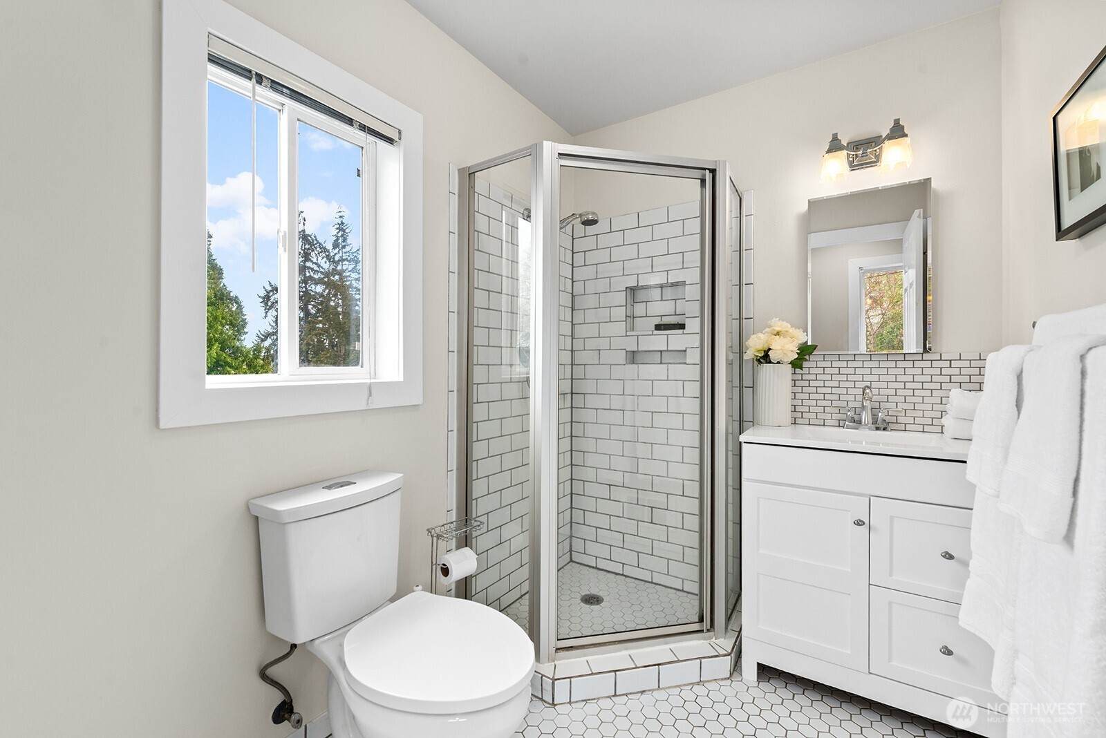 2620 East Roy Street Seattle, WA 98112 - Photo 21 of 27 a bathroom with a granite countertop toilet a sink and a mirror