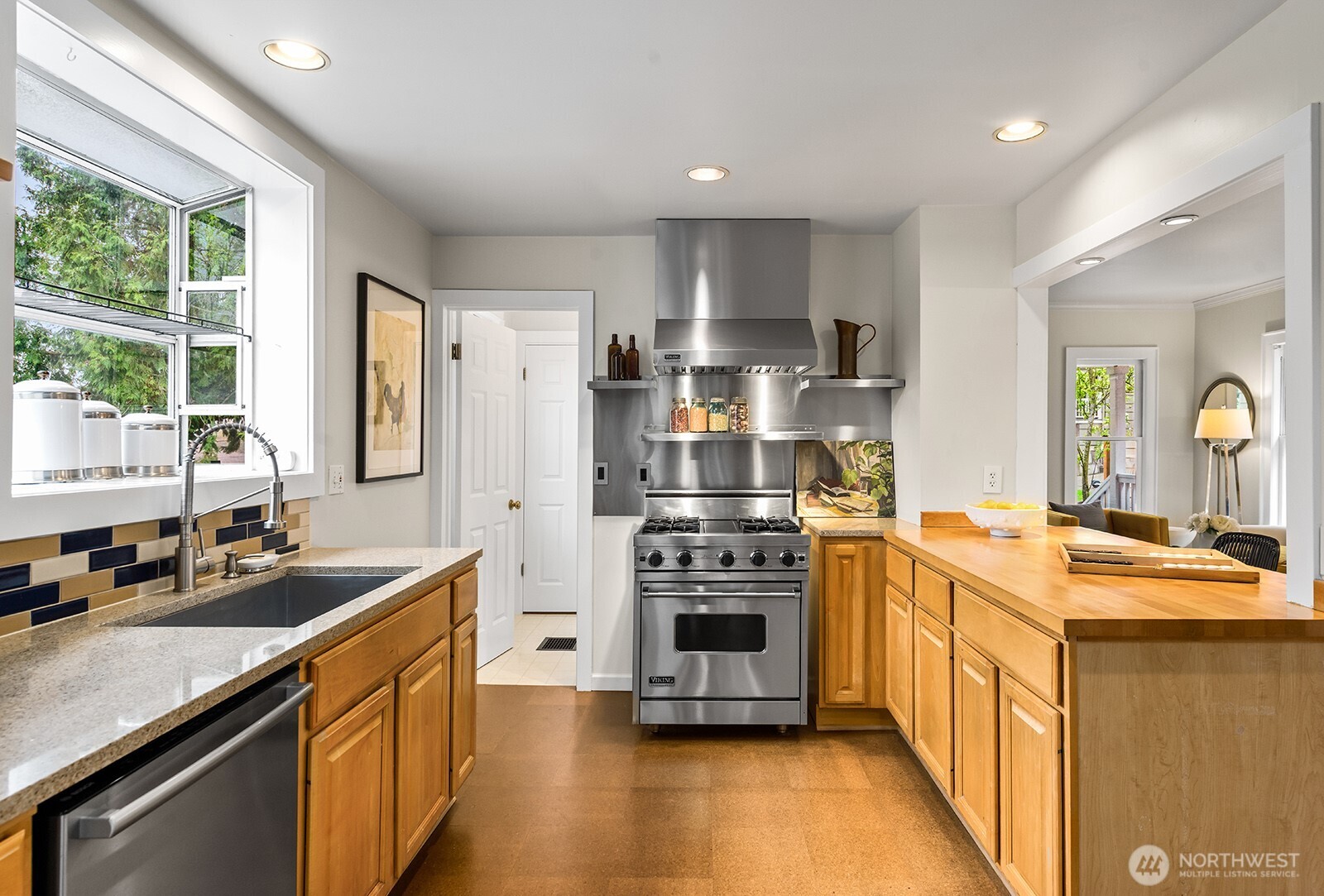 2620 East Roy Street Seattle, WA 98112 - Photo 7 of 27 a kitchen with stainless steel appliances granite countertop a sink stove and refrigerator