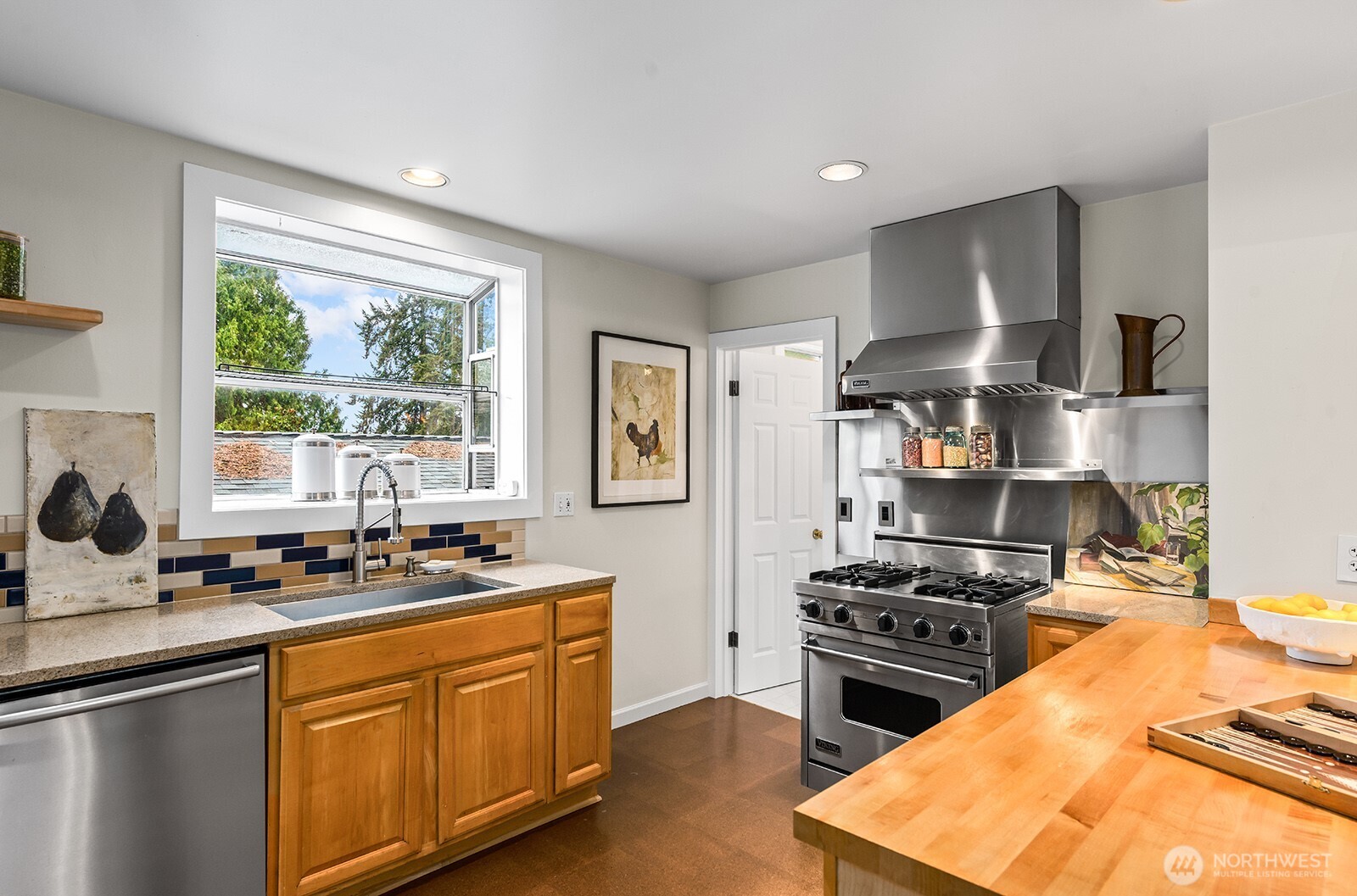 2620 East Roy Street Seattle, WA 98112 - Photo 8 of 27 a kitchen with a stove a sink and a refrigerator