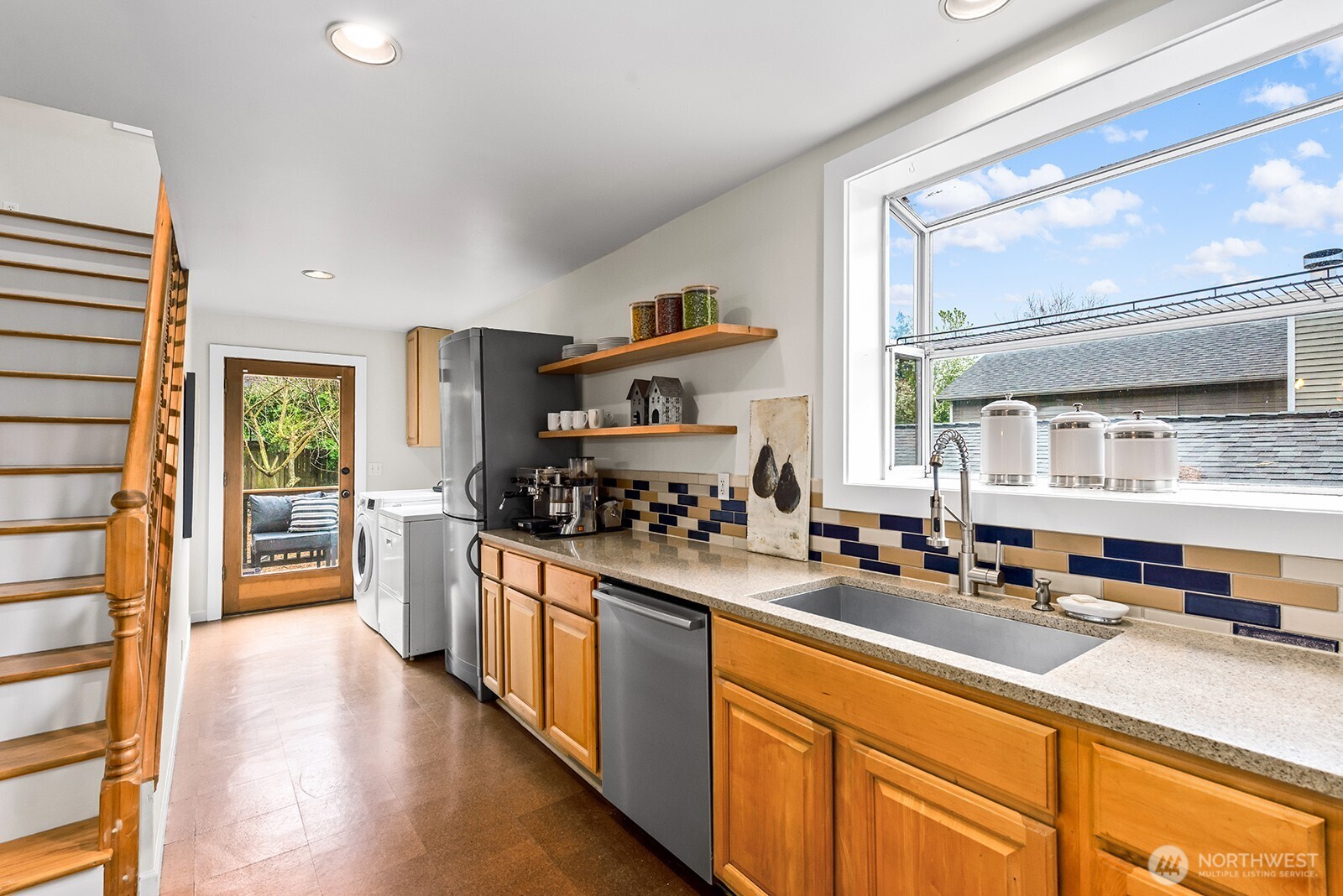 2620 East Roy Street Seattle, WA 98112 - Photo 10 of 27 a kitchen with stainless steel appliances a sink and a stove
