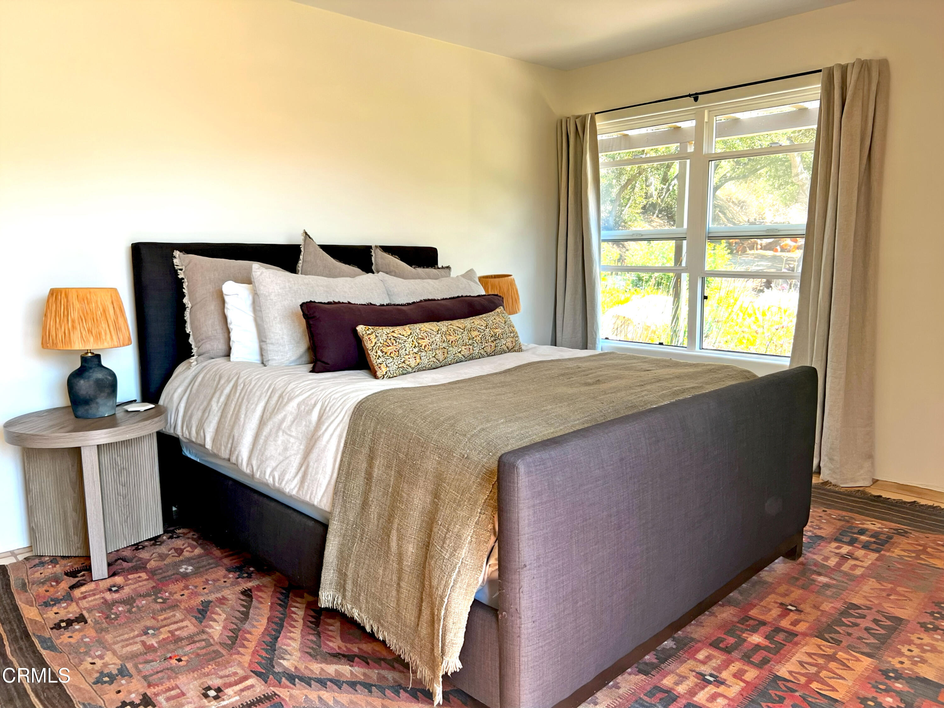 3000 East Ojai Avenue Ojai, CA 93023 - Photo 18 of 34 a bedroom with a bed and wooden floor