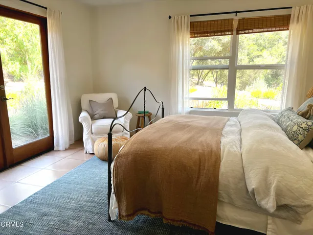 a view of a house with swimming pool and sitting area