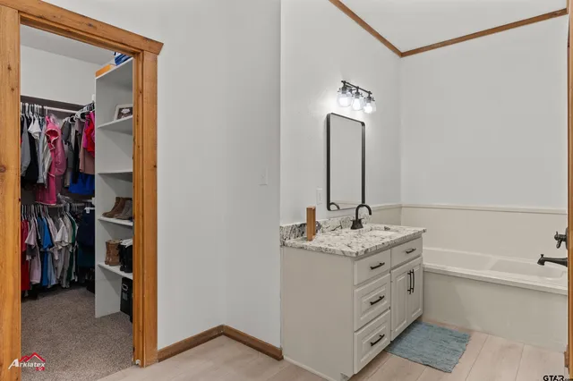 a bathroom with a double vanity sink and a mirror
