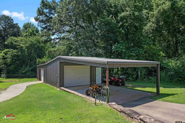 a view of a chair and table in the garden