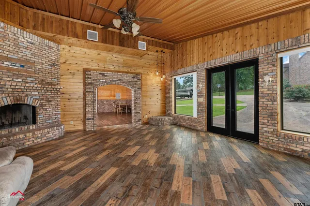 a view of empty room with wooden floor and fireplace