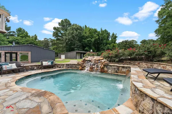 a view of a swimming pool and lounge chair