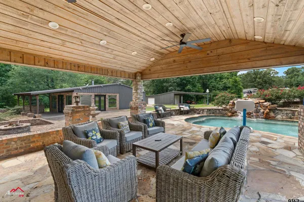 a view of patio with couches and pool