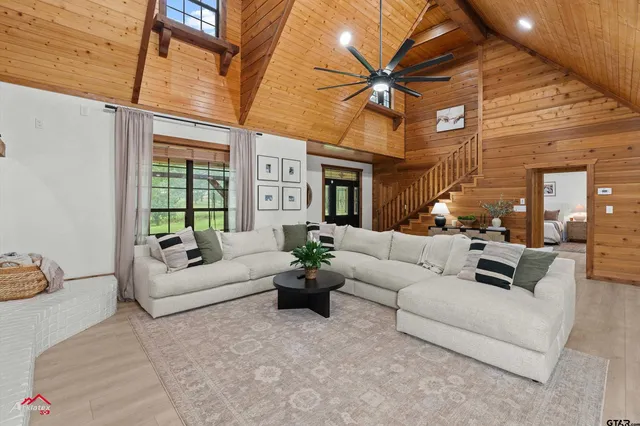 a living room with furniture a chandelier and a dining table with chandelier