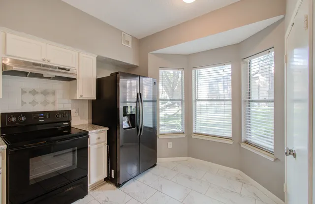 a kitchen with a refrigerator stove and microwave