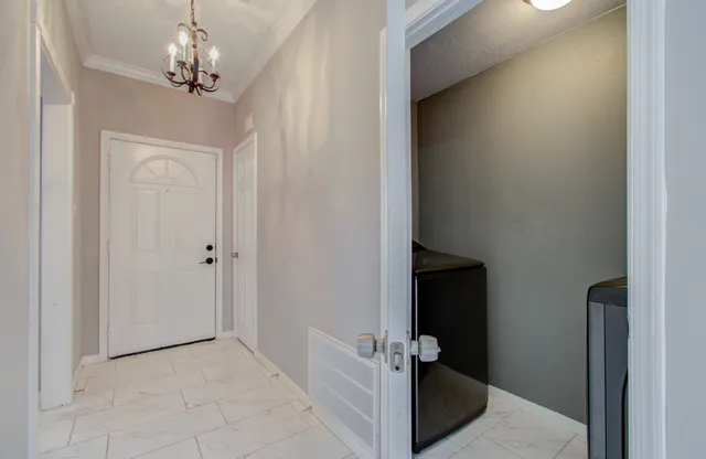 a view of a hallway to a room with a hallway