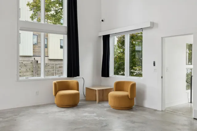 a view of a backyard with plants and outdoor seating