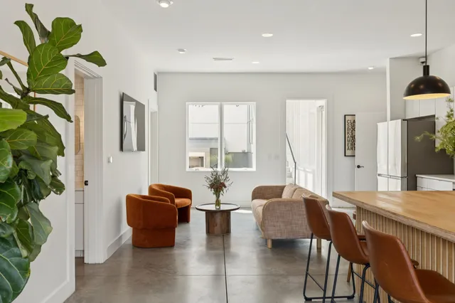 a kitchen with stainless steel appliances granite countertop a stove a sink a microwave a dining table and chairs