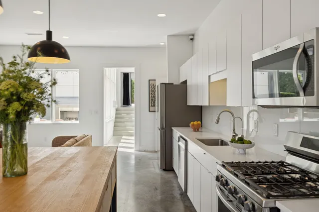a view of kitchen with dining table and stainless steel appliances
