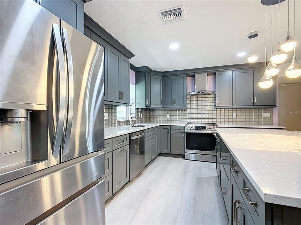 295 Locust Pass Ocala, FL 34472 - Photo 13 of 62 a large kitchen with a large window and stainless steel appliances