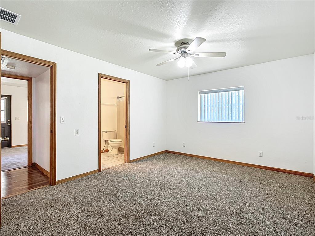 295 Locust Pass Ocala, FL 34472 - Photo 20 of 62 an empty room with windows and fan