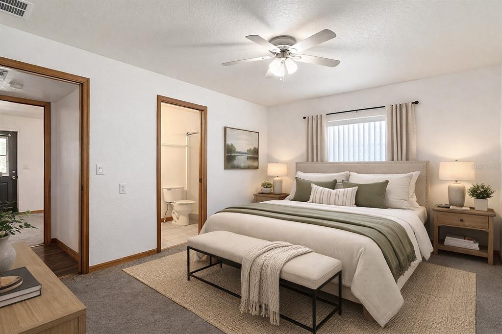 295 Locust Pass Ocala, FL 34472 - Photo 21 of 62 a bedroom with a bed and a chandelier
