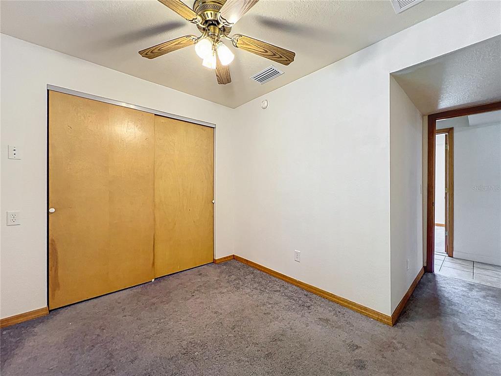 295 Locust Pass Ocala, FL 34472 - Photo 24 of 62 an empty room with a ceiling fan and a chandelier fan