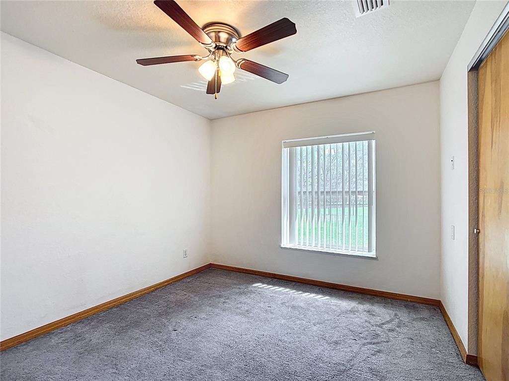295 Locust Pass Ocala, FL 34472 - Photo 28 of 62 an empty room with windows and fan