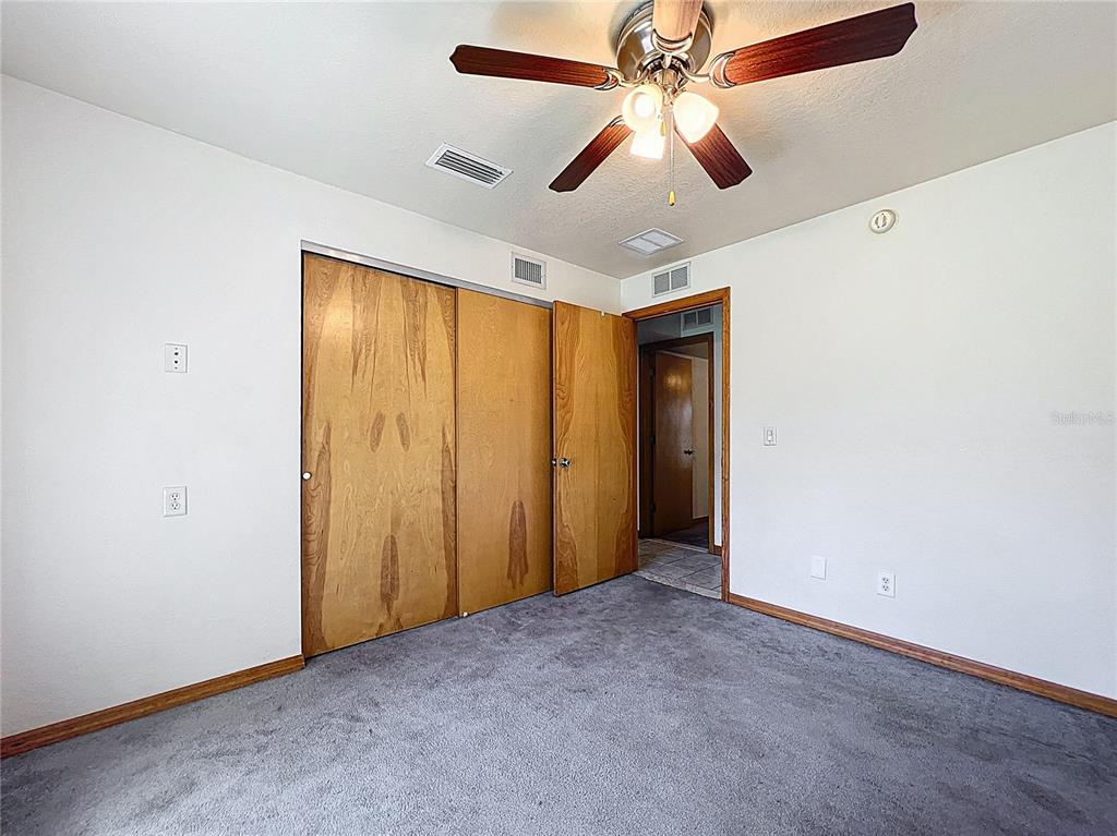 295 Locust Pass Ocala, FL 34472 - Photo 31 of 62 an empty room with closet and a ceiling fan