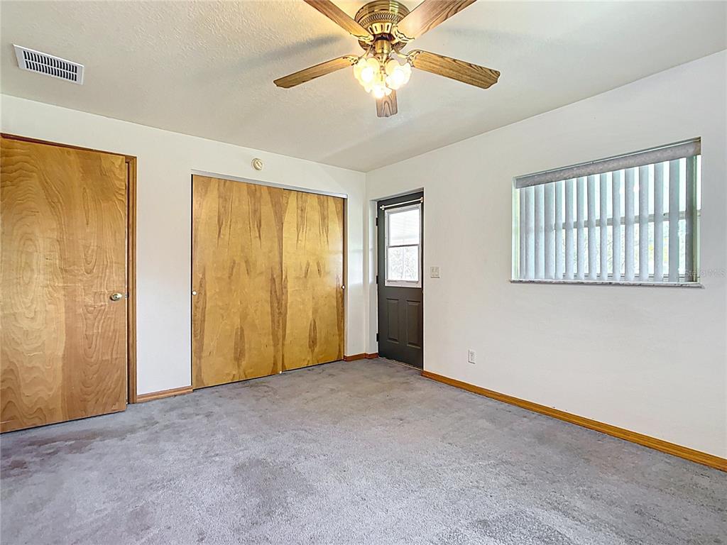 295 Locust Pass Ocala, FL 34472 - Photo 33 of 62 a view of an empty room with chandelier fan and a window