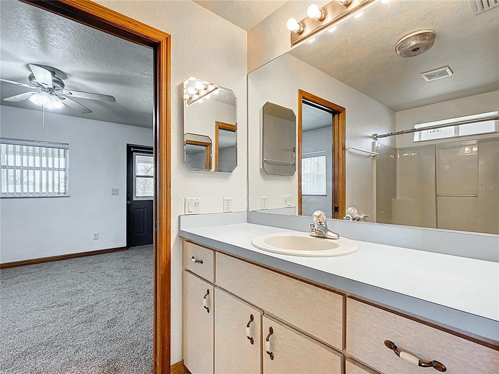 295 Locust Pass Ocala, FL 34472 - Photo 36 of 62 a bathroom with a sink and a mirror