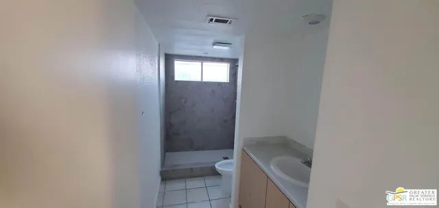 a bathroom with a tub shower and sink