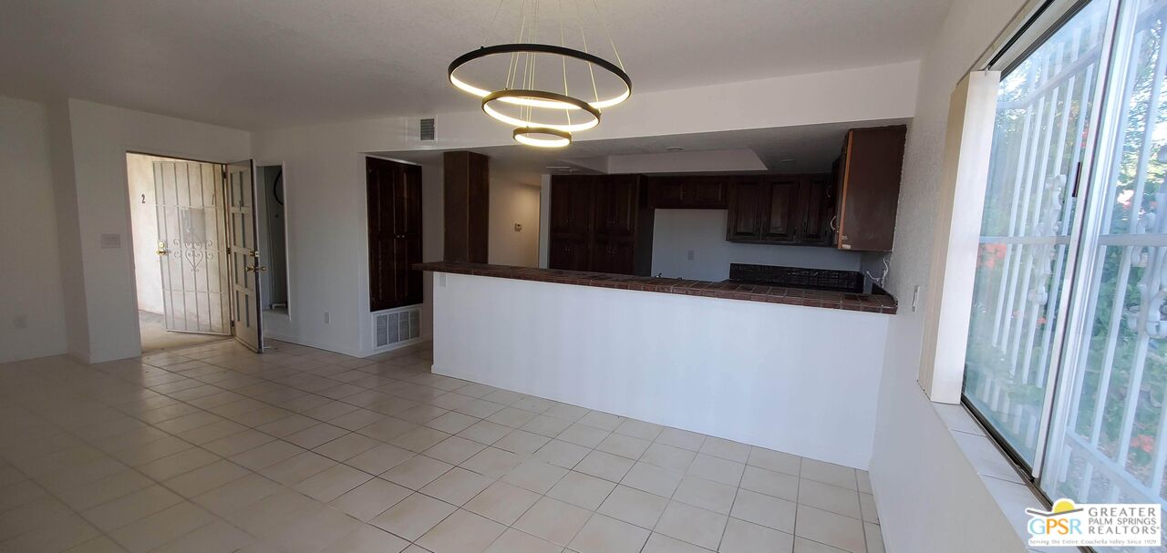 66565 12th Street, Unit 1 Desert Hot Springs, CA 92240 - Photo 8 of 10 a view of a hallway with wooden shelves
