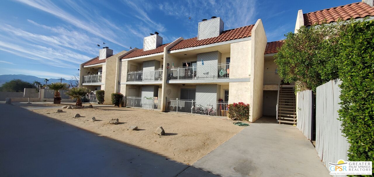 66565 12th Street, Unit 1 Desert Hot Springs, CA 92240 - Photo 10 of 10 a view of a house with a barbeque and large trees
