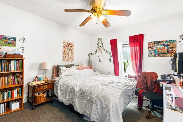 a bedroom with a bed and a book shelf