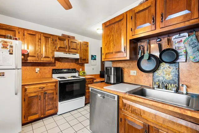 a kitchen with stainless steel appliances granite countertop a stove and a sink