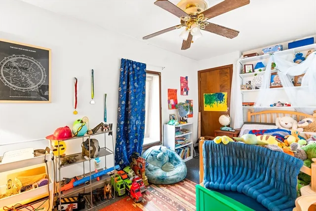 a bedroom with furniture a couch and a fan