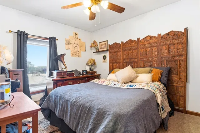 a bedroom with bed and a chandelier