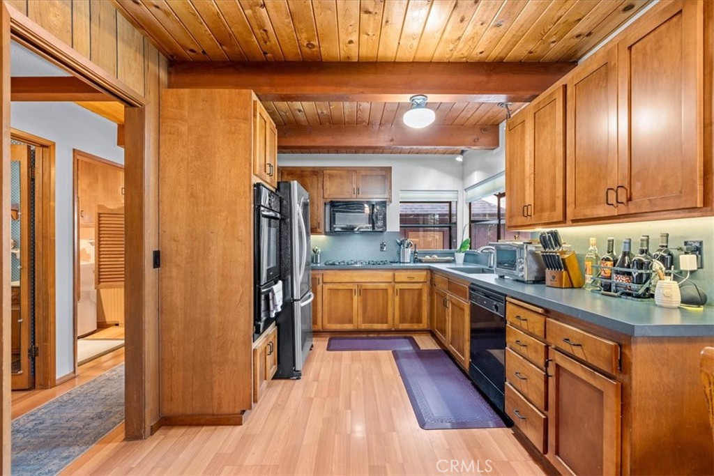 1631 Linnet Road Wrightwood, CA 92397 - Photo 13 of 42 a kitchen with stainless steel appliances kitchen island granite countertop a refrigerator and a stove top oven