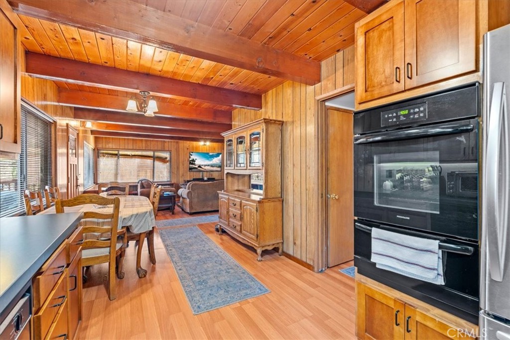 1631 Linnet Road Wrightwood, CA 92397 - Photo 15 of 42 a living room with stainless steel appliances kitchen island granite countertop furniture a rug and a window